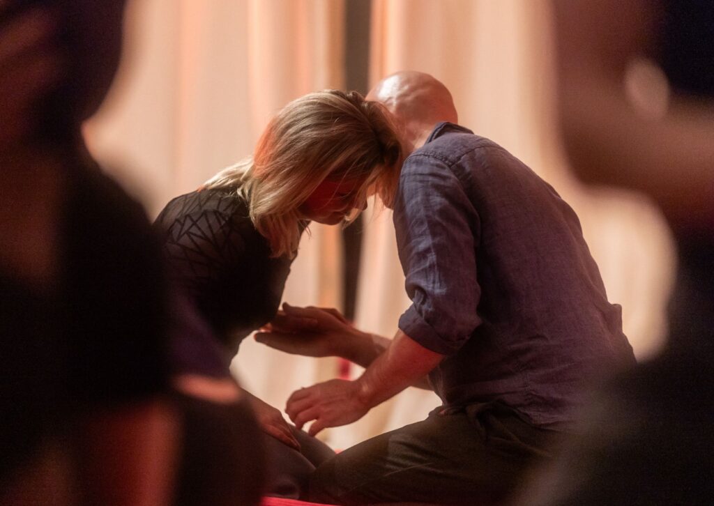Couple exploring polarity in loving presence at a sensual shibari workshop