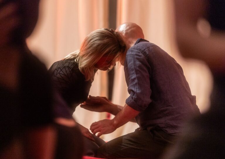 Couple exploring polarity in loving presence at a sensual shibari workshop